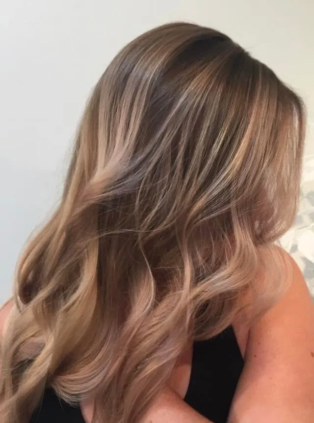 Long ash brown hair with soft balayage waves, seen from behind.