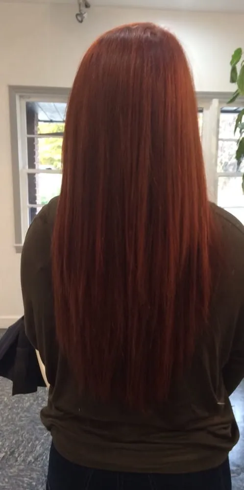 Long straight copper red hair, seen from behind.